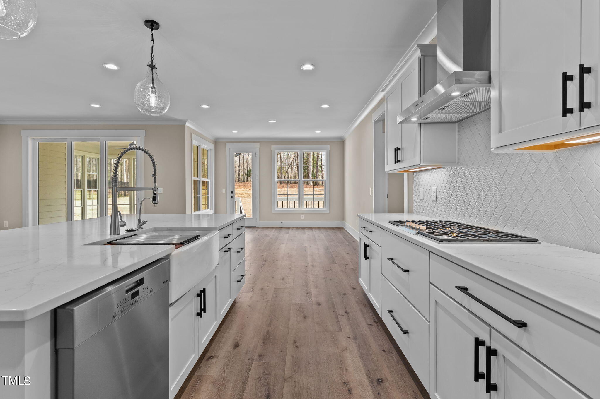 3816 Old Milburnie Road Raleigh, NC 27616 - Photo 29 of 58 a large kitchen with granite countertop a large stove top oven a sink dishwasher and wooden floor