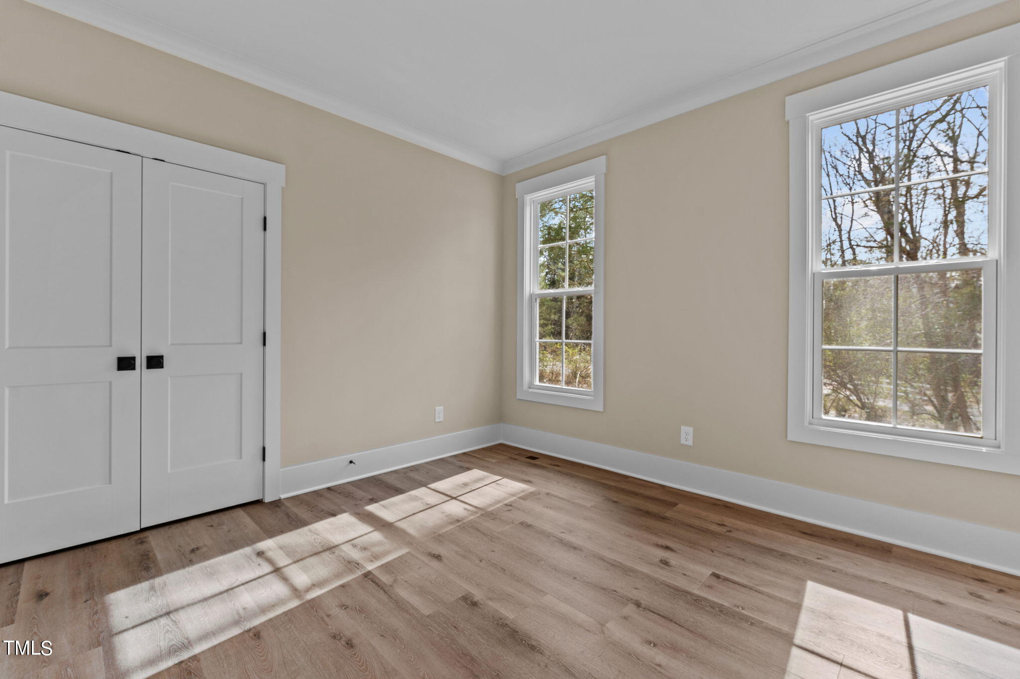 3816 Old Milburnie Road Raleigh, NC 27616 - Photo 34 of 58 a view of an empty room with a window and wooden floor