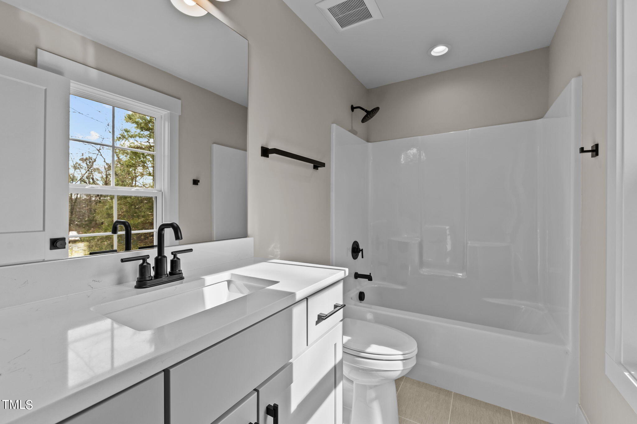 3816 Old Milburnie Road Raleigh, NC 27616 - Photo 42 of 58 a bathroom with a sink a toilet a mirror and shower