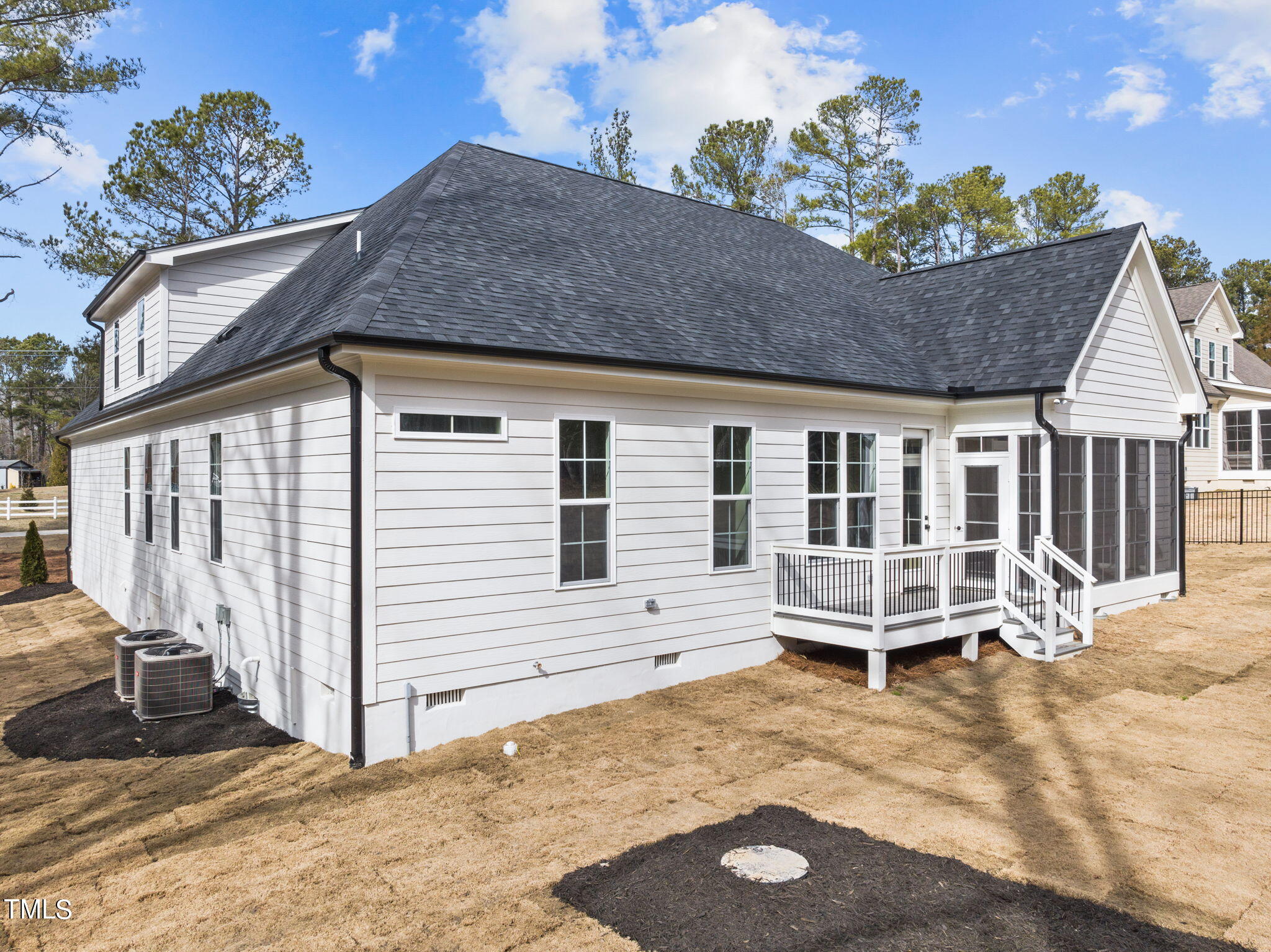 3816 Old Milburnie Road Raleigh, NC 27616 - Photo 52 of 58 a backyard of a house with wooden fence and a large tree