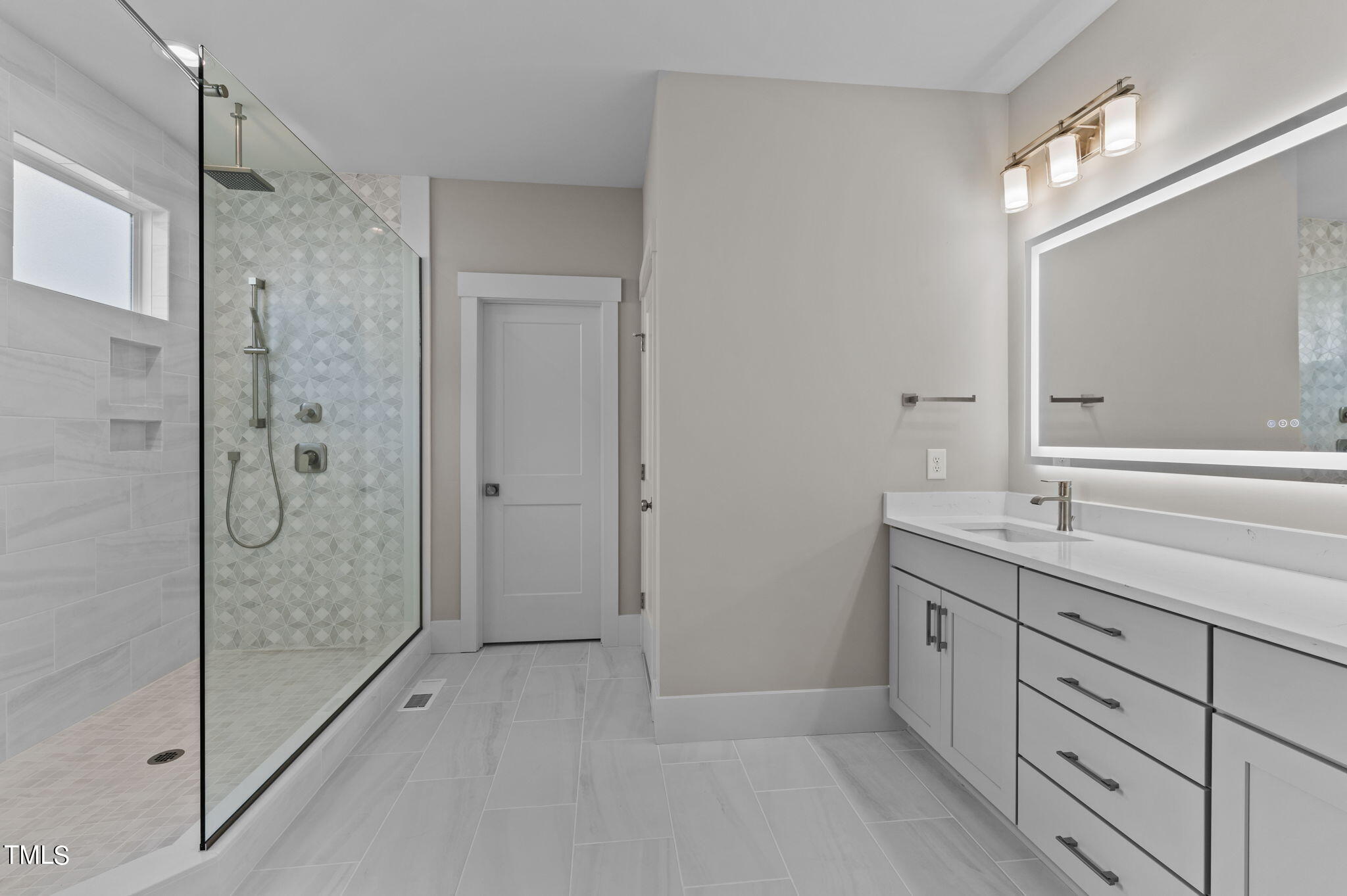 3816 Old Milburnie Road Raleigh, NC 27616 - Photo 8 of 58 a bathroom with a shower sink and mirror