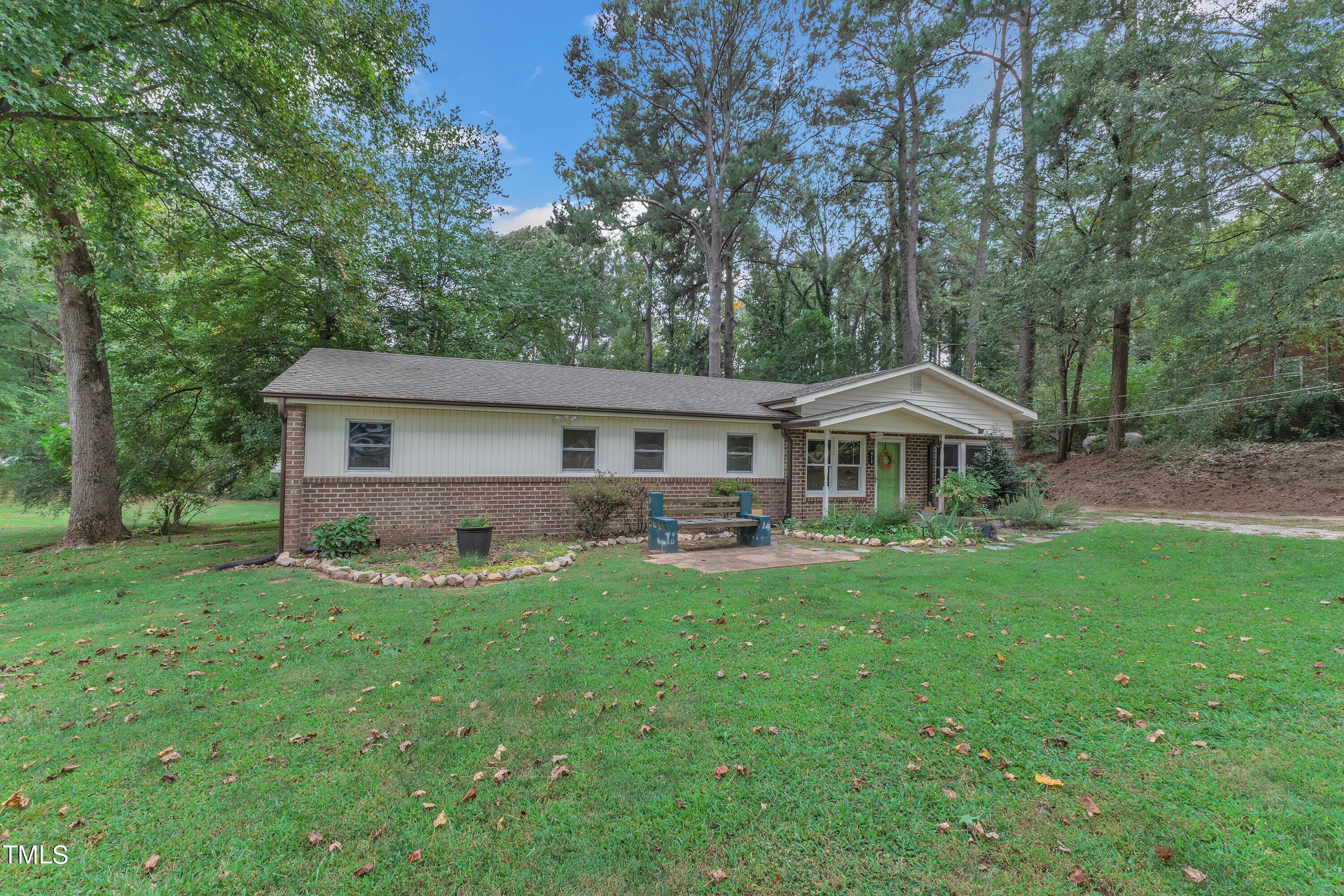 a front view of a house with yard patio and green space