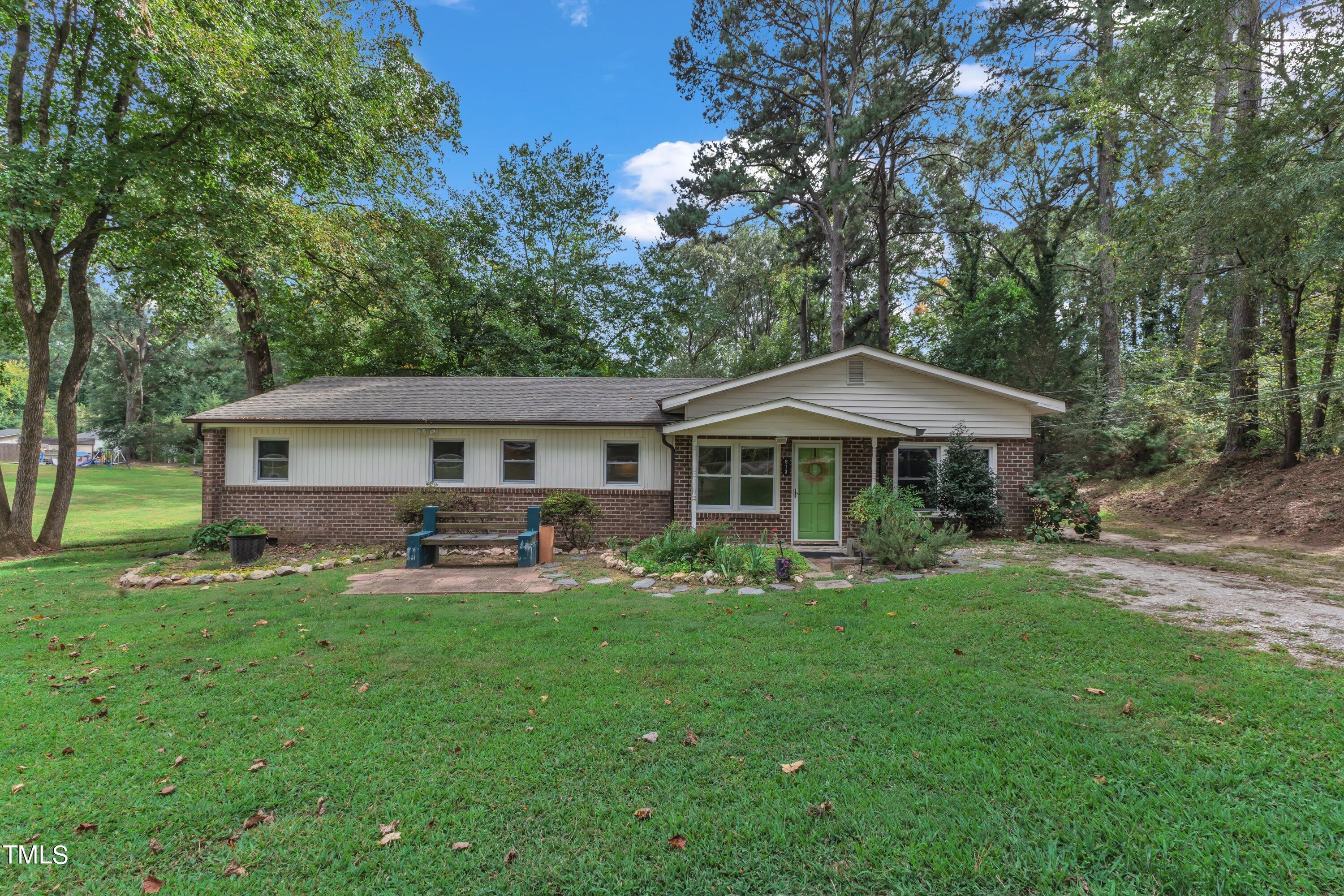 913 Ranch Farm Road Raleigh, NC 27603 - Photo 3 of 19 a front view of a house with garden