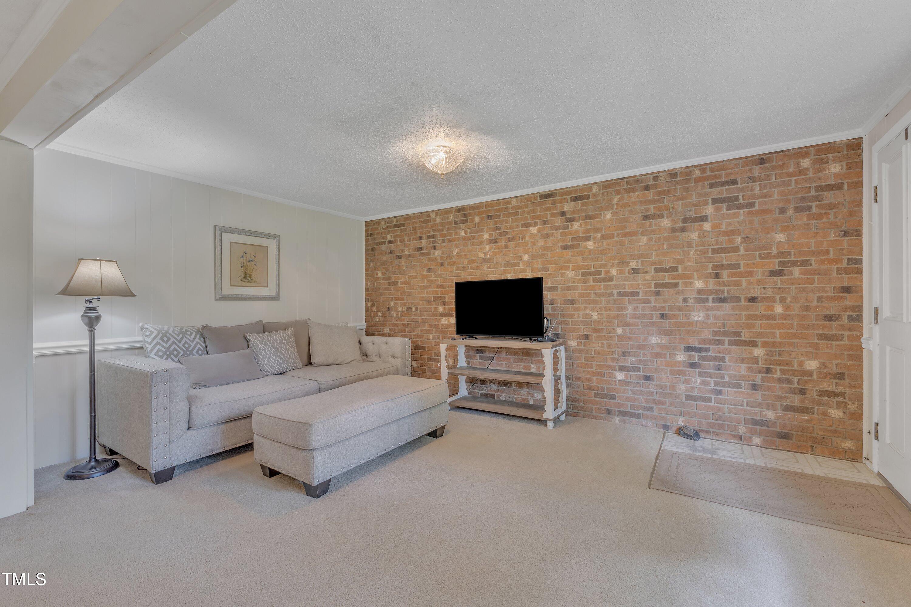 913 Ranch Farm Road Raleigh, NC 27603 - Photo 5 of 19 a living room with furniture and a flat screen tv
