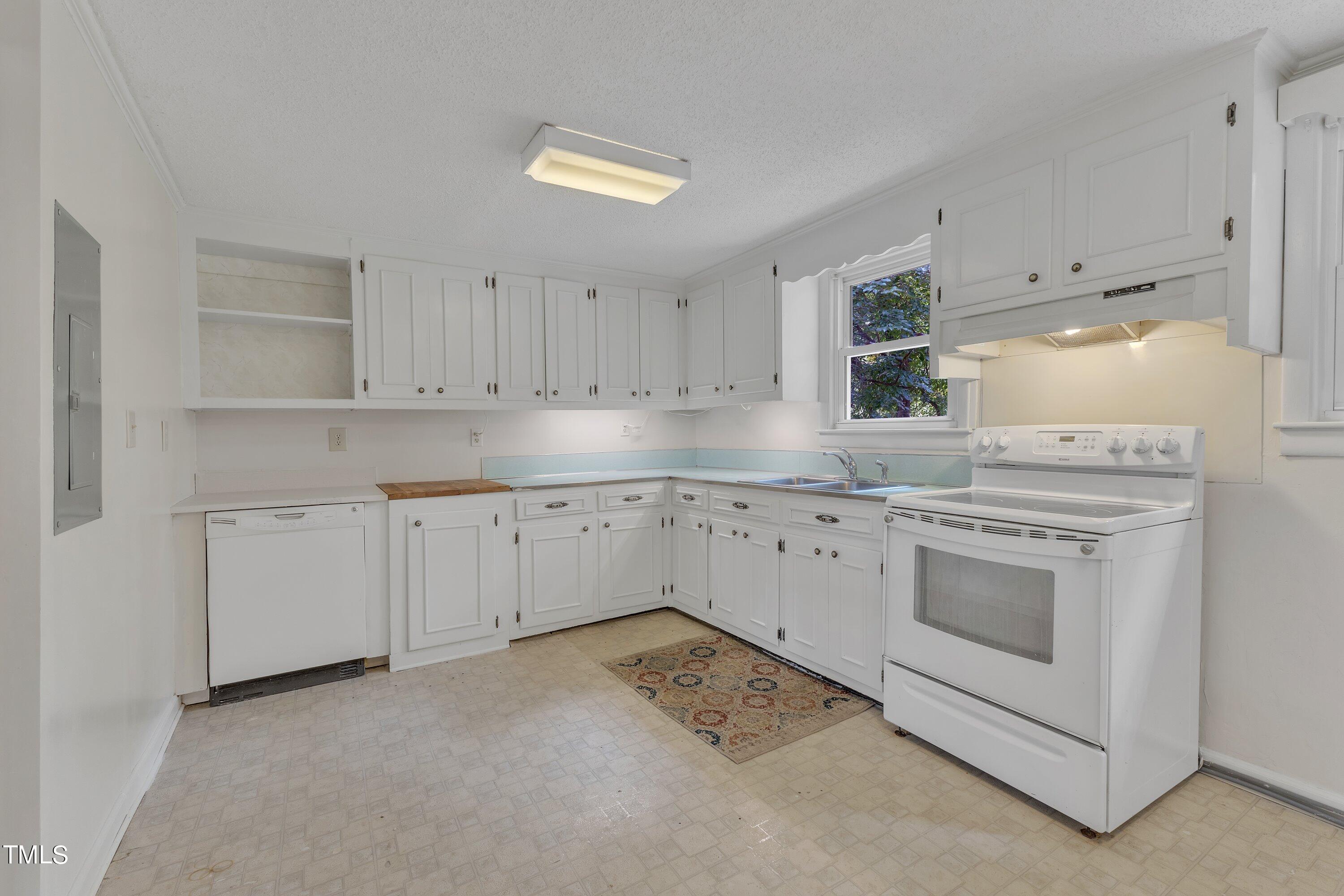 913 Ranch Farm Road Raleigh, NC 27603 - Photo 7 of 19 a kitchen with white cabinets and white appliances