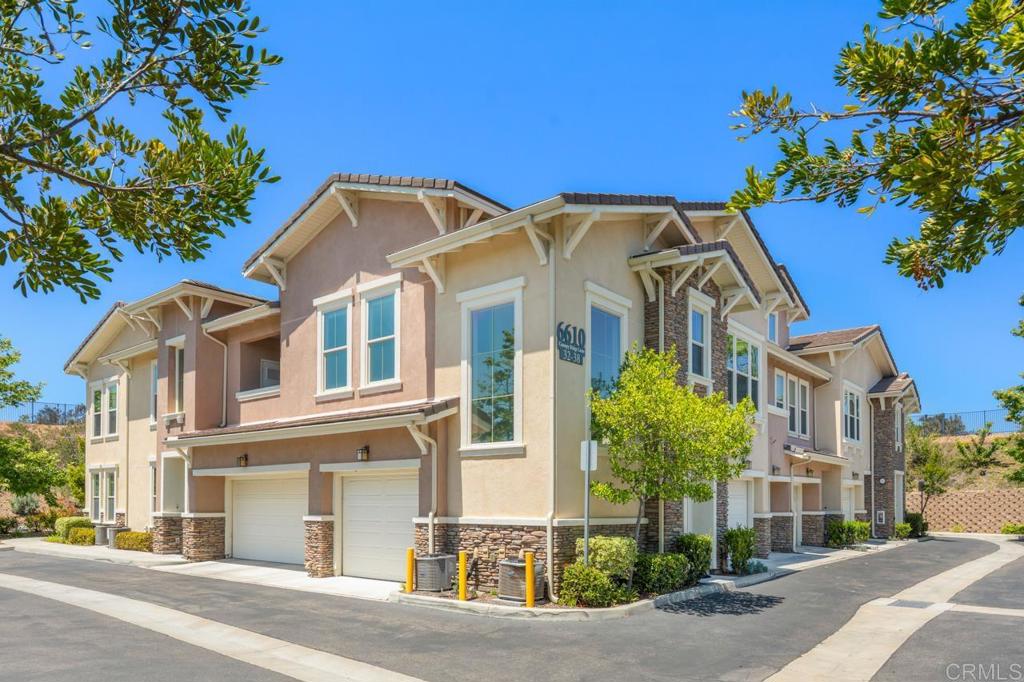 6610 Canopy Ridge Lane, Unit 37 San Diego, CA 92121 - Photo 1 of 65 a view of a white house with a yard