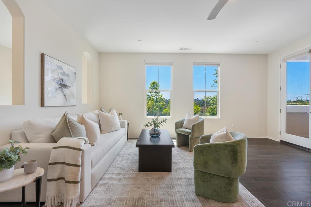 6610 Canopy Ridge Lane, Unit 37 San Diego, CA 92121 - Photo 12 of 65 a living room with furniture and a large window