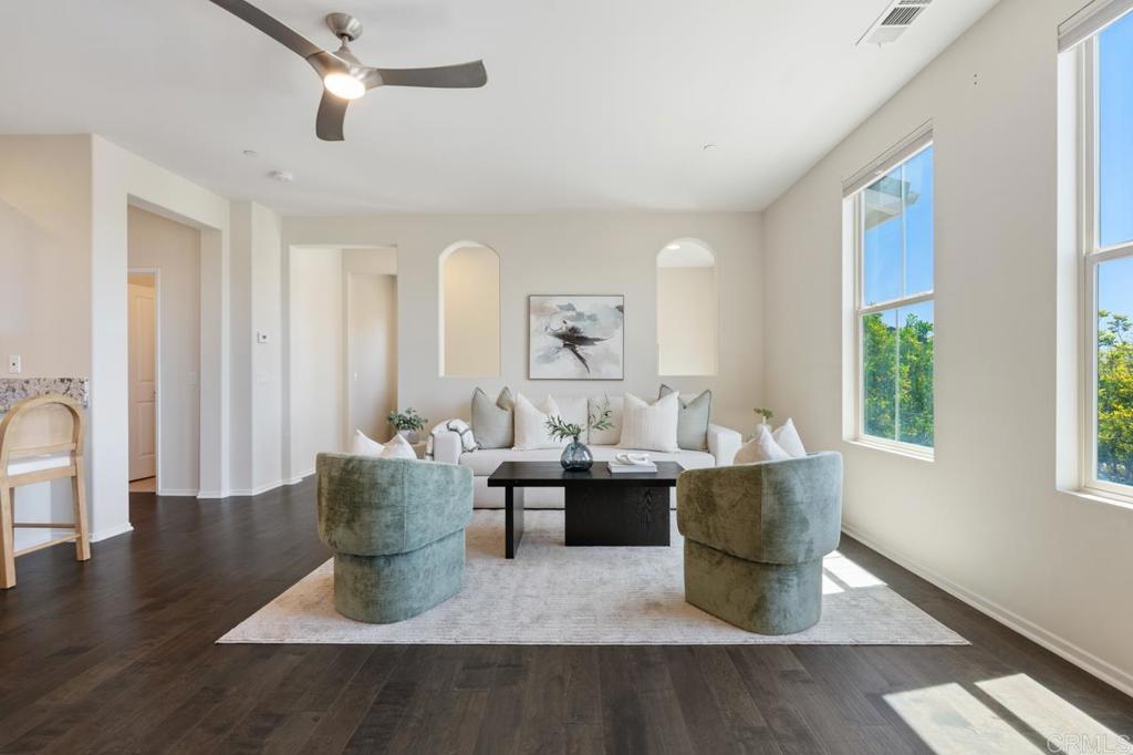 6610 Canopy Ridge Lane, Unit 37 San Diego, CA 92121 - Photo 18 of 65 a dining room with wooden floor a chandelier a glass table and chairs