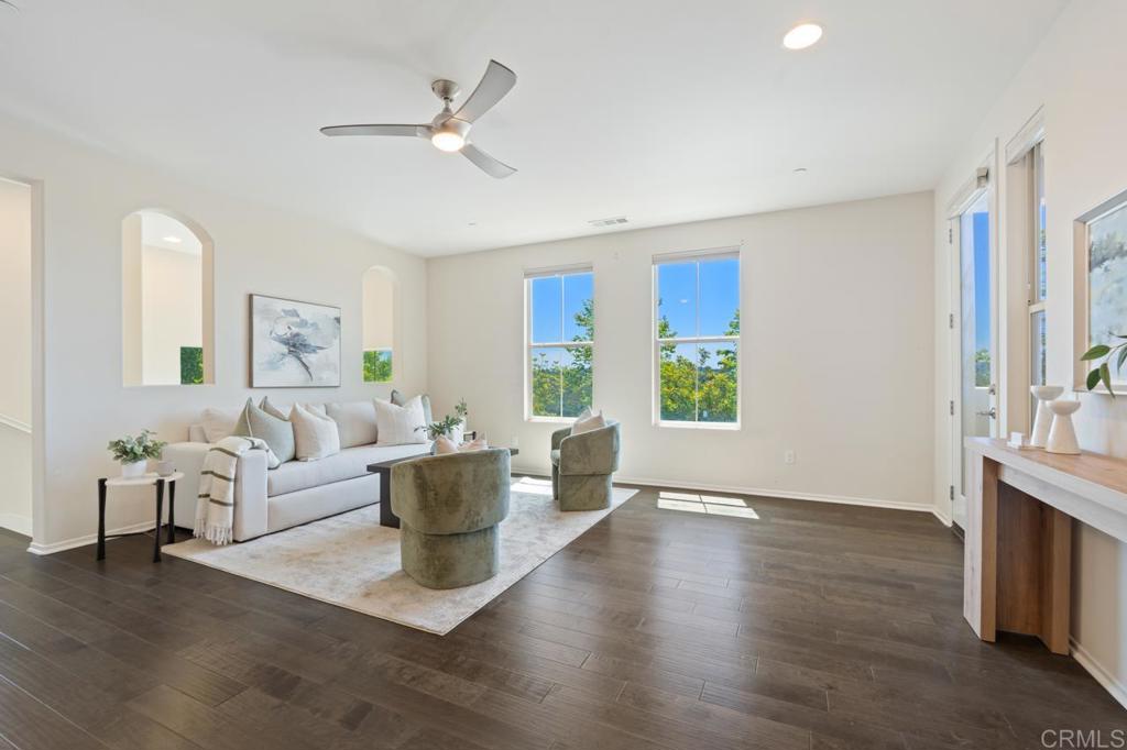 6610 Canopy Ridge Lane, Unit 37 San Diego, CA 92121 - Photo 19 of 65 a living room with couches a coffee table and a large window with wooden floor