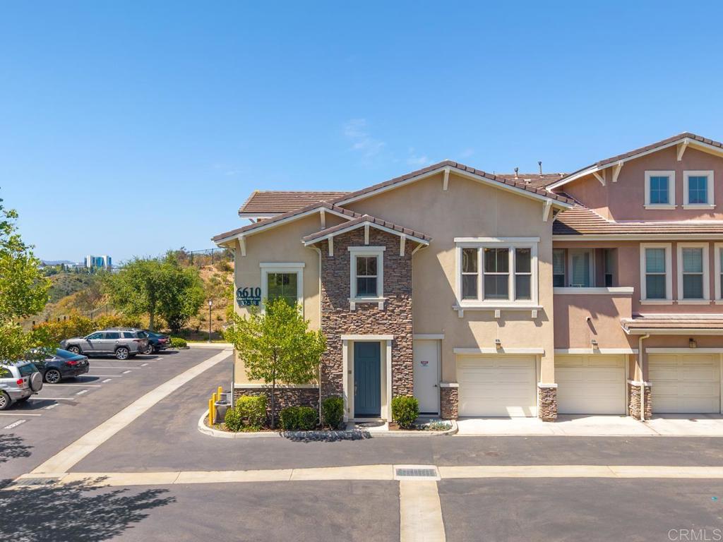 6610 Canopy Ridge Lane, Unit 37 San Diego, CA 92121 - Photo 2 of 65 a front view of a house with a garden and parking