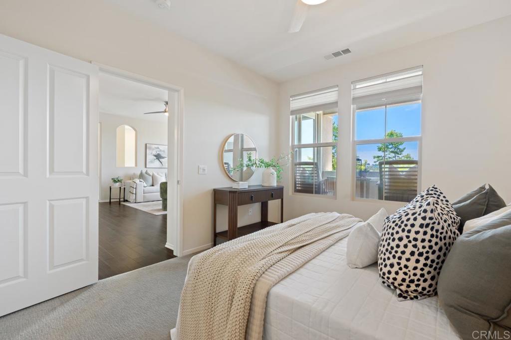 6610 Canopy Ridge Lane, Unit 37 San Diego, CA 92121 - Photo 33 of 65 a bedroom with a bed and walk in closet with wooden floor