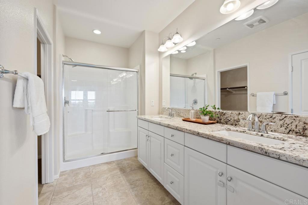 6610 Canopy Ridge Lane, Unit 37 San Diego, CA 92121 - Photo 34 of 65 a bathroom with a double vanity sink mirror and shower