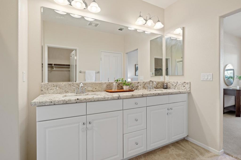 6610 Canopy Ridge Lane, Unit 37 San Diego, CA 92121 - Photo 36 of 65 a bathroom with a granite countertop double vanity sink and a mirror