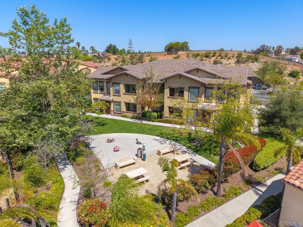 6610 Canopy Ridge Lane, Unit 37 San Diego, CA 92121 - Photo 4 of 65 a view of a white house with a big yard and large trees