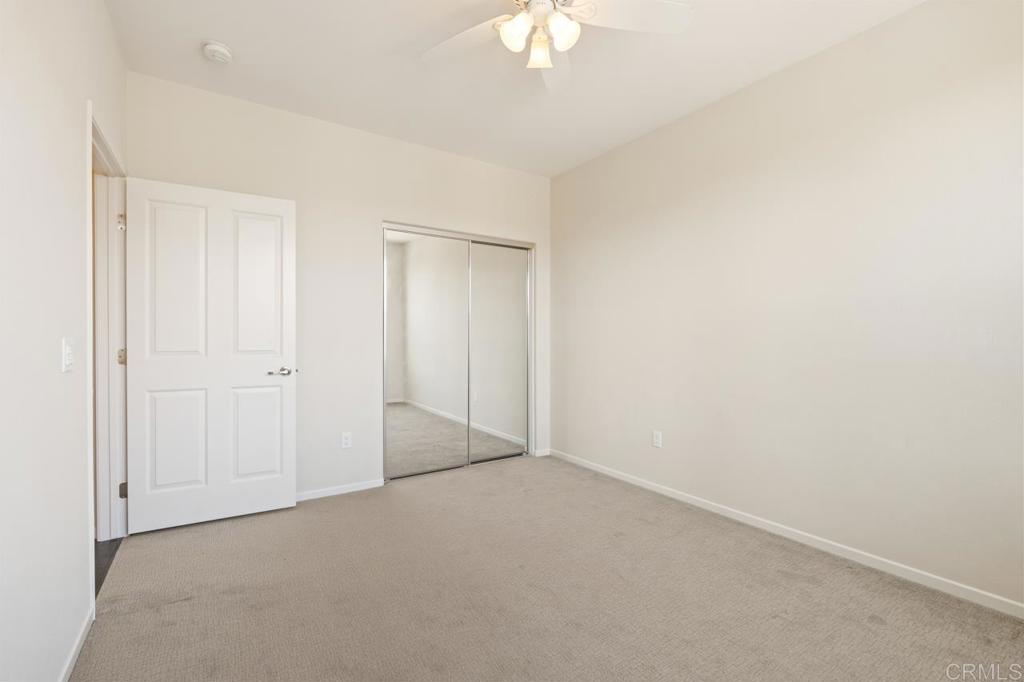 6610 Canopy Ridge Lane, Unit 37 San Diego, CA 92121 - Photo 44 of 65 an empty room with a chandelier fan