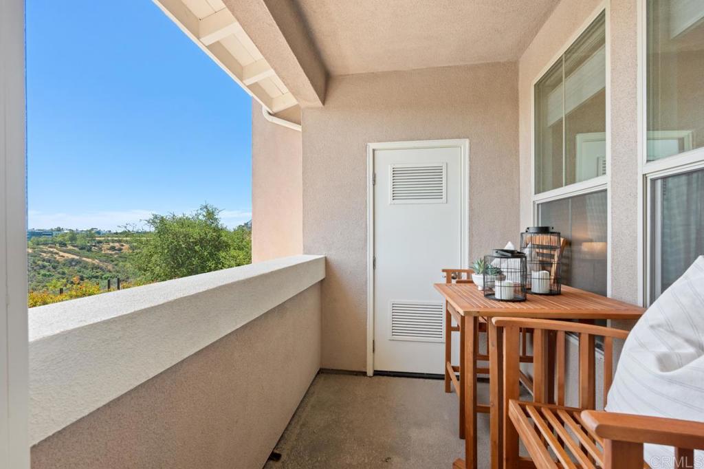 6610 Canopy Ridge Lane, Unit 37 San Diego, CA 92121 - Photo 45 of 65 a dining room with furniture and a floor to ceiling window