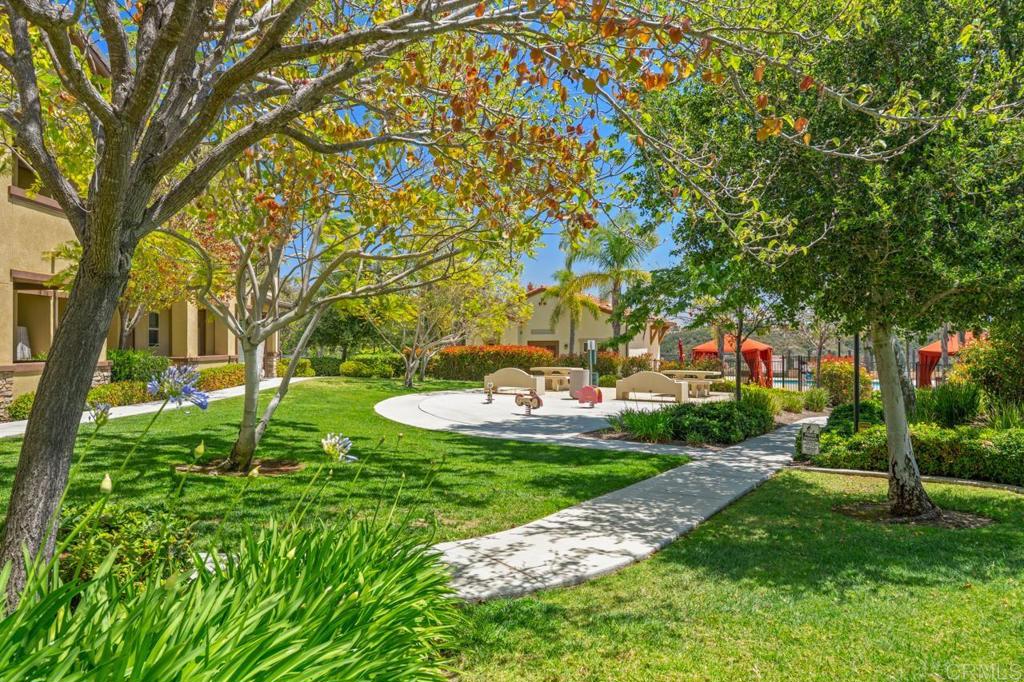 6610 Canopy Ridge Lane, Unit 37 San Diego, CA 92121 - Photo 53 of 65 a backyard of a house with table and chairs