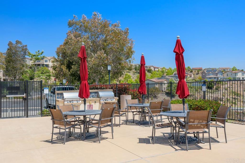 6610 Canopy Ridge Lane, Unit 37 San Diego, CA 92121 - Photo 56 of 65 a view of a patio with a table and chairs and wooden fence