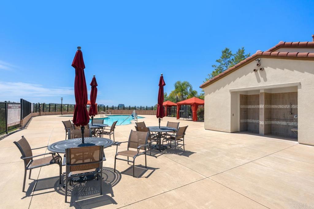 6610 Canopy Ridge Lane, Unit 37 San Diego, CA 92121 - Photo 57 of 65 a view of a patio with a table and chairs and potted plants