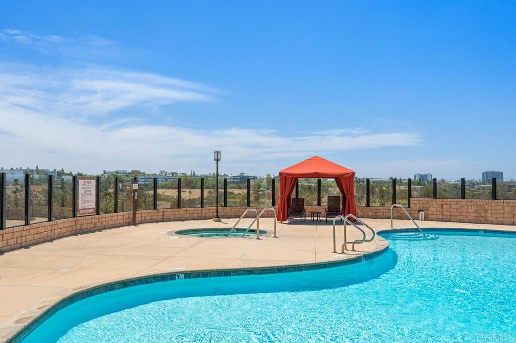 6610 Canopy Ridge Lane, Unit 37 San Diego, CA 92121 - Photo 59 of 65 a view of a swimming pool with a patio and a yard