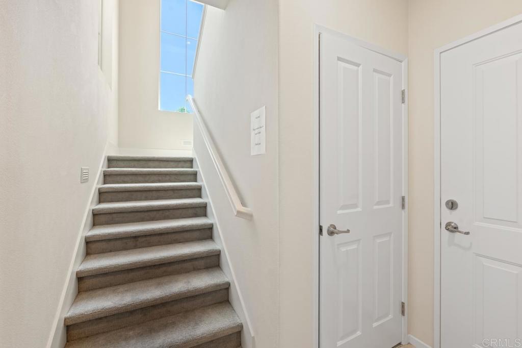 6610 Canopy Ridge Lane, Unit 37 San Diego, CA 92121 - Photo 8 of 65 a view of staircase with white walls and white door