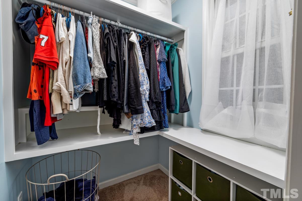 1336 Dylan Heath Court Raleigh, NC 27608 - Photo 19 of 25 a view of walk in closet with clothes and shoes