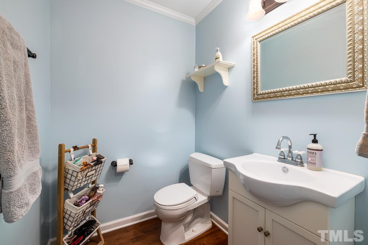 1336 Dylan Heath Court Raleigh, NC 27608 - Photo 20 of 25 a bathroom with a sink mirror and toilet