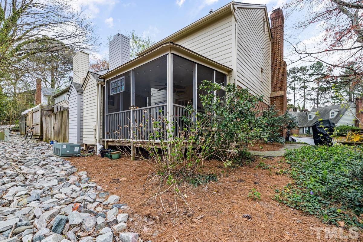 1336 Dylan Heath Court Raleigh, NC 27608 - Photo 2 of 25 a backyard of a house with plants and trees