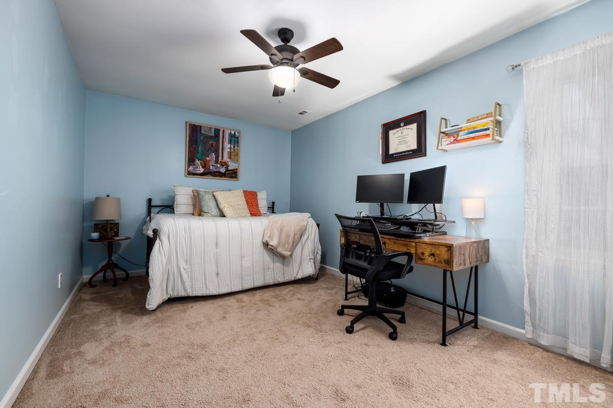 1336 Dylan Heath Court Raleigh, NC 27608 - Photo 21 of 25 a bedroom with a workspace