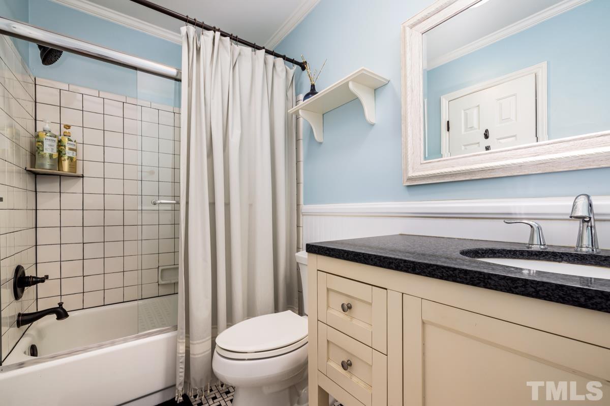 1336 Dylan Heath Court Raleigh, NC 27608 - Photo 23 of 25 a bathroom with a granite countertop sink a toilet and shower