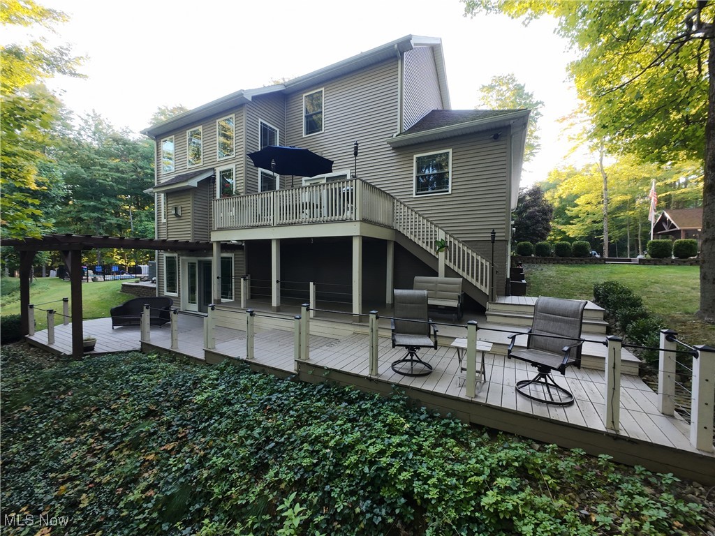 5232 Emerson Road Madison, OH 44057 - Photo 2 of 48 Back of property featuring a deck, outdoor lounge area, a lawn, and stairway