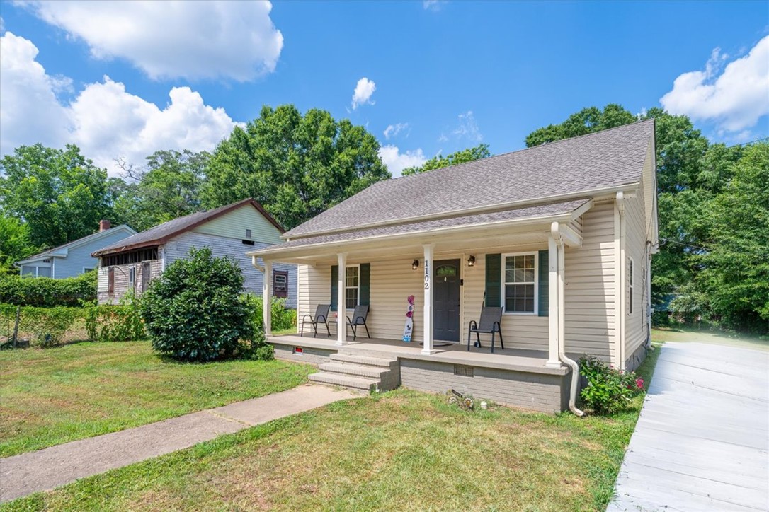 1102 West End Avenue Anderson, SC 29625 - Photo 2 of 28 A charming single-story residence boasts a welcoming front porch and mature landscaping.