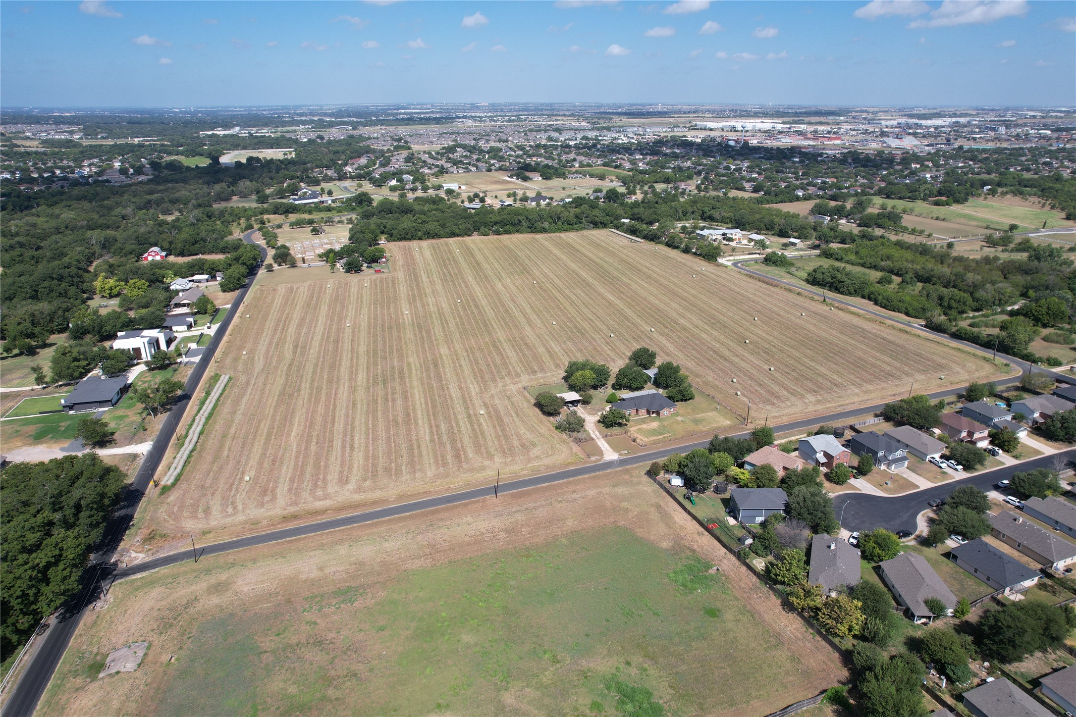135 Rd Hutto Tx 78634 Road Hutto, TX 78634 - Photo 1 of 10 A vast agricultural tract spans the landscape near developing residential neighborhoods.
