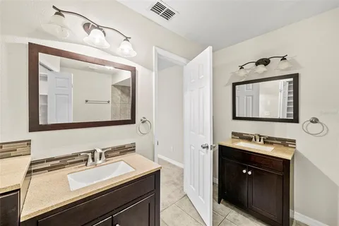 a bathroom with a sink vanity and mirror