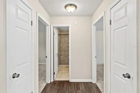 a view of a hallway with wooden floor