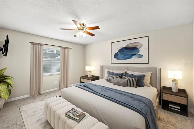 a bedroom with a large bed and a chandelier