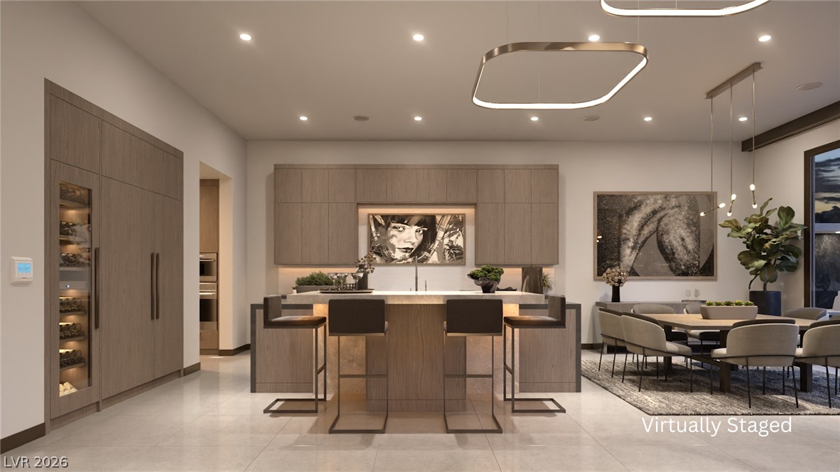 543 Overlook Rim Drive Henderson, NV 89012 - Photo 3 of 19 A well-lit, contemporary kitchen and dining space with integrated appliances.