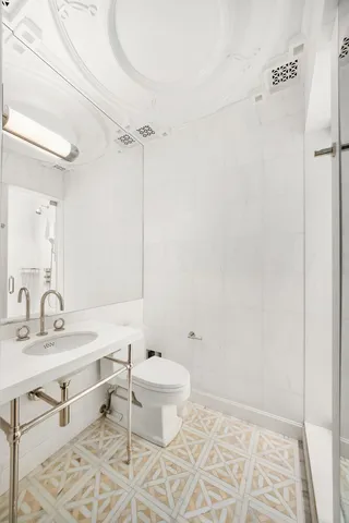 a bathroom with a sink toilet a mirror and vanity