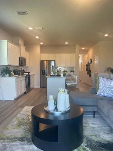 a view of kitchen with stainless steel appliances granite countertop a stove and a refrigerator