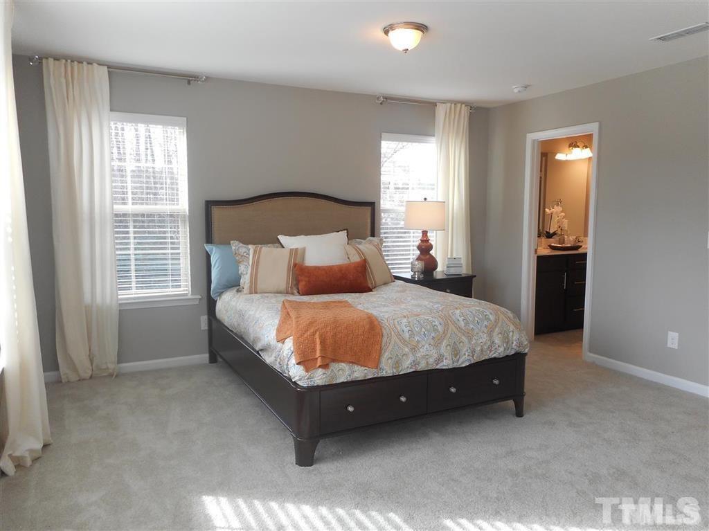 3713 Landshire View Lane Raleigh, NC 27616 - Photo 7 of 15 a spacious bedroom with a bed and a window