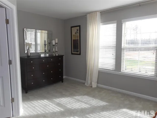 a room with a dresser and a window