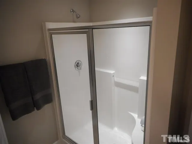 a bathroom with a glass shower door