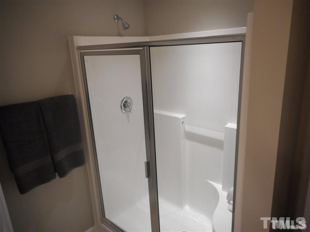 3713 Landshire View Lane Raleigh, NC 27616 - Photo 9 of 15 a bathroom with a glass shower door