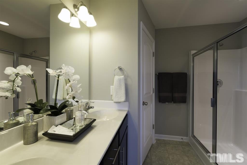3713 Landshire View Lane Raleigh, NC 27616 - Photo 10 of 15 a bathroom with a double vanity sink and a mirror