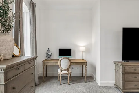 a view of a workspace with furniture and a flat screen tv