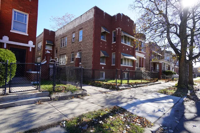 a view of a brick building next to a road