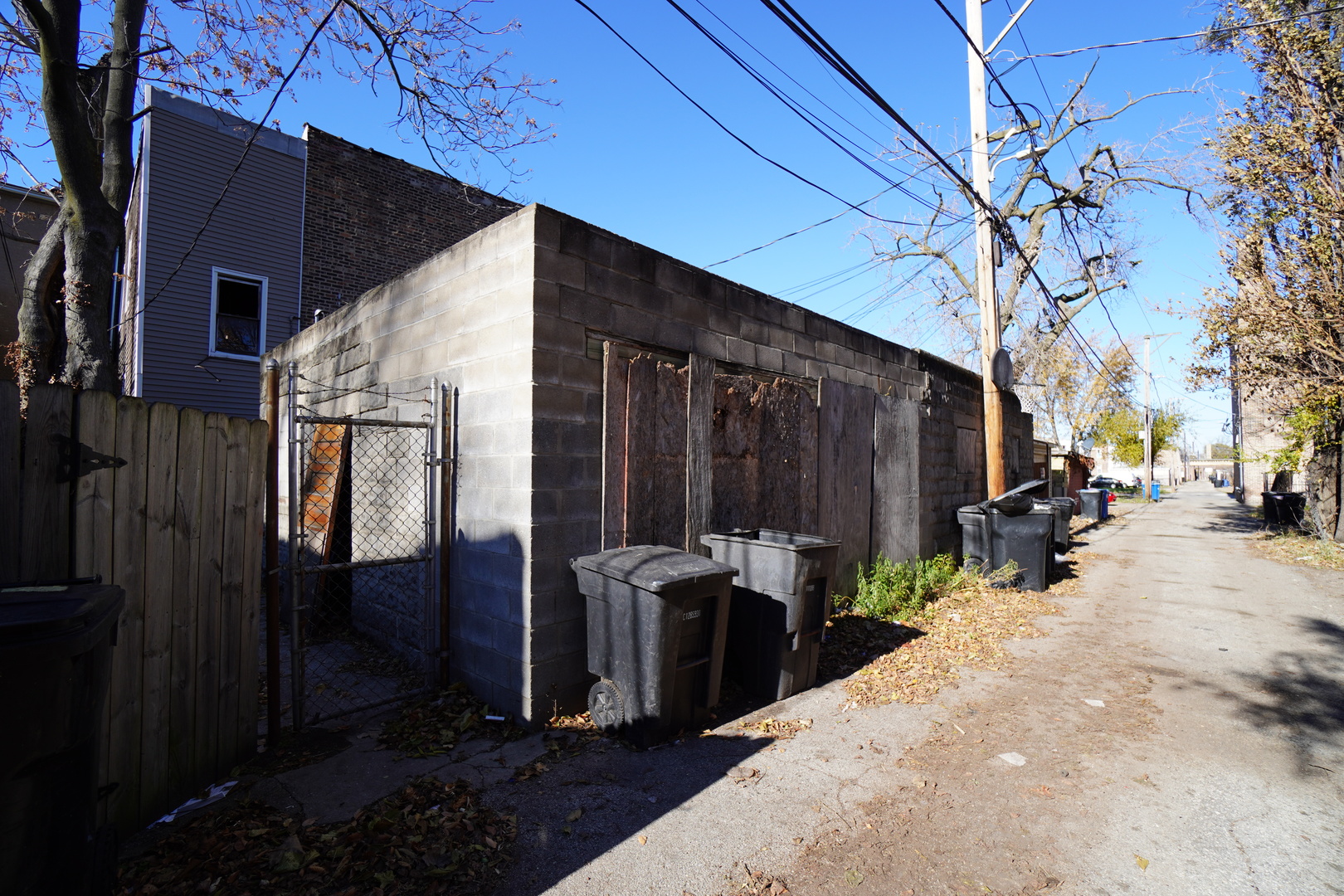 6419 South Morgan Street Chicago, IL 60621 - Photo 11 of 11 a view of a patio with table and chairs and barbeque grill with wooden fence