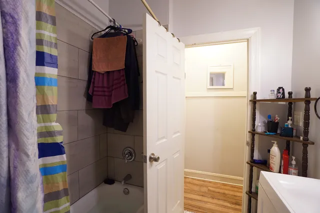 a bathroom with a bathtub and shower