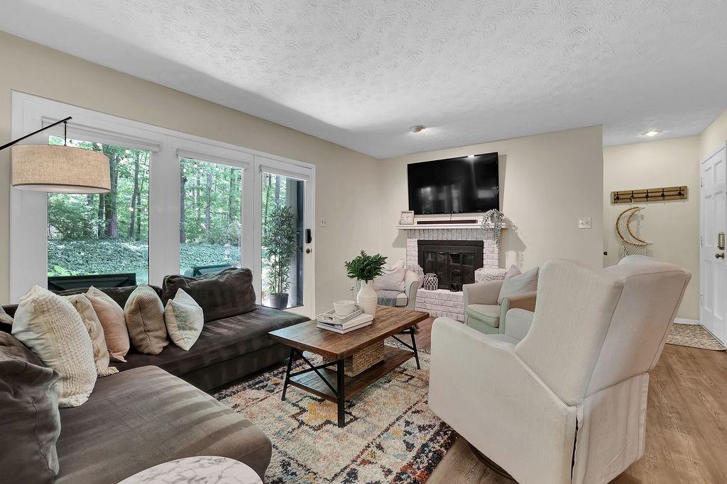 208 Tuxworth Circle Decatur, GA 30033 - Photo 1 of 1 a living room with furniture a flat screen tv and a fireplace