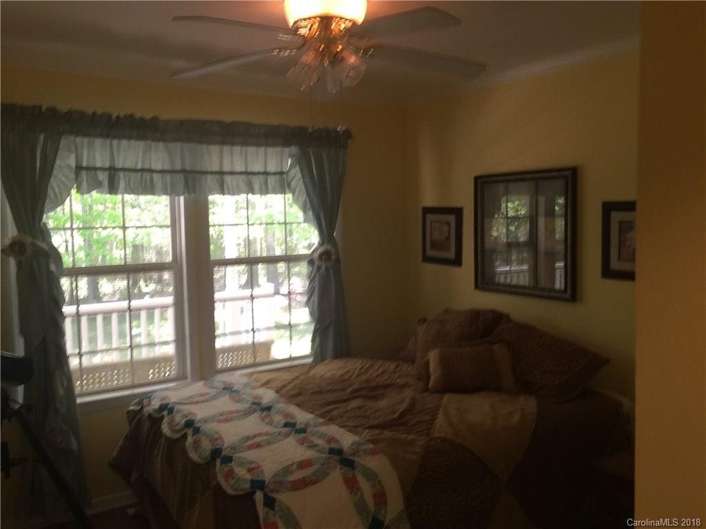 5825 Cress Road Concord, NC 28025 - Photo 14 of 23 a bed sitting in a bedroom next to a window